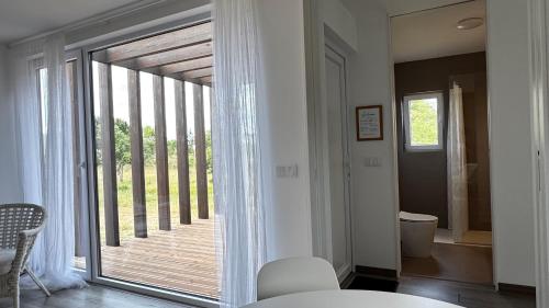 a room with a large sliding glass door to a balcony at LAZY HIKERS by Nature Bliss in São Luis
