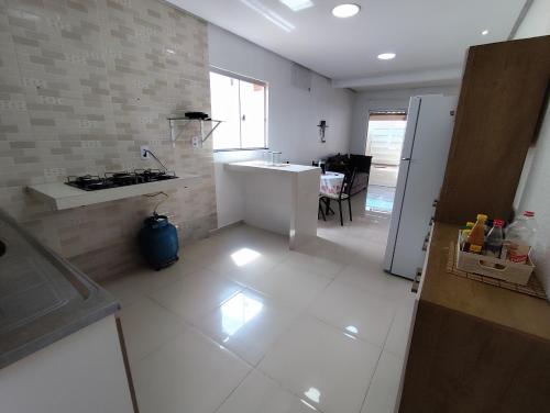 a kitchen with a sink and a stove in it at Aluguel por Temporada Marabá - São Félix in Marabá