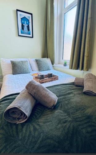 a large bed with pillows on it in a bedroom at Harrington House - Perfect for contractors Sleeps 15 in Workington