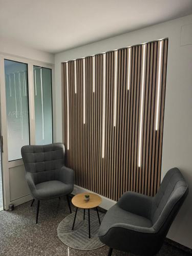a waiting room with two chairs and a table and a window at VILLA ŠIMOVIĆ APARTMENTS in Baška Voda