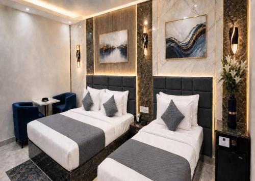 a hotel room with two beds in a room at Hotel GRAN-SOL Near DELHI Airport in New Delhi