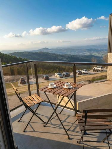 a wooden table and two chairs on a balcony at Studio Vidik Sofija in Divčibare