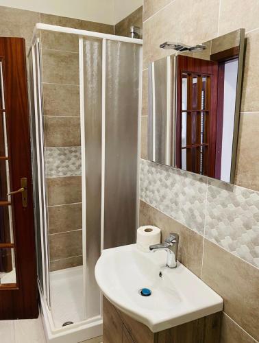 a bathroom with a sink and a shower at Casa palli in Camerota
