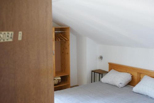 a small bedroom with a bed and a closet at House Magdic Plitvice in Grabovac