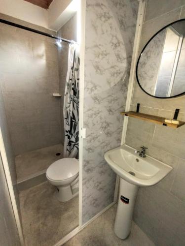 a bathroom with a toilet and a sink at Hotel Coralite Suites Santa Marta in Santa Marta
