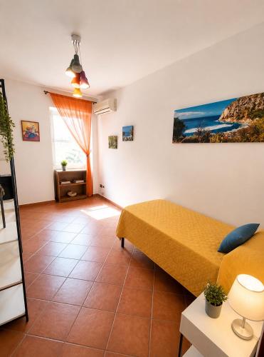 a small room with a bed and a window at Domus Pannella - Endless Summer in Lacco Ameno