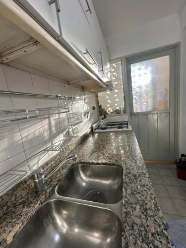 a kitchen with a stainless steel sink in a counter at La Pausa Misiones in Posadas