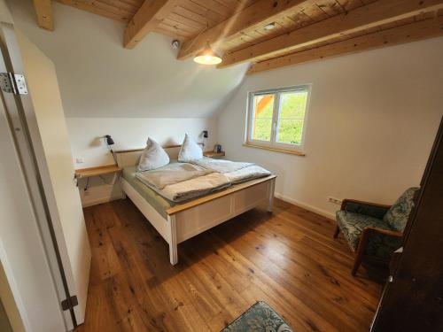 a bedroom with a bed and a window at Öko Wohnung Garten und Pool in Lindau-Bodolz