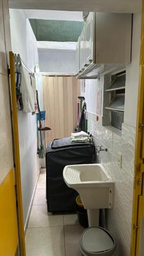 a small bathroom with a toilet and a sink at HOSTEL Divinópolis in Divinópolis