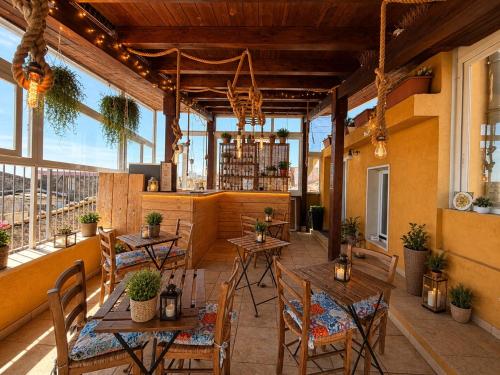a restaurant with tables and chairs and windows at Suites Sangiovanni in Ragusa