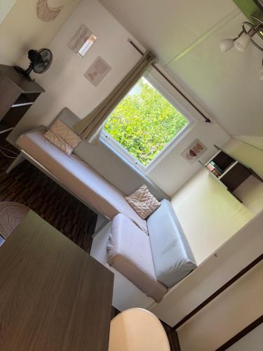 an overhead view of a couch in a tiny house at Cozy bungalow in Ivry-la-Bataille