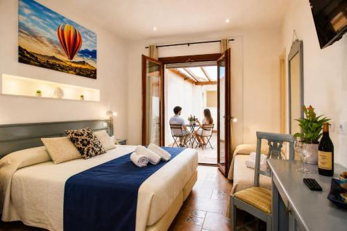 a hotel room with a bed and a balcony at Central Dorgali Guest House in Dorgali