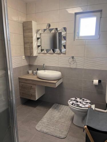 a bathroom with a sink and a toilet at Luxury apartment Duće with private pool in Omiš