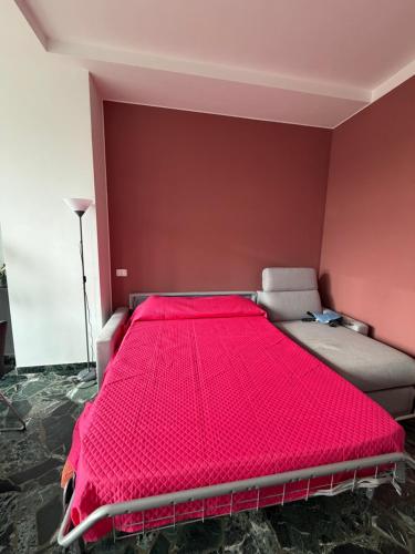 a bedroom with a bed with a red wall at STANZA matrimoniale metro M5 - Bignami, Carroponte in Sesto San Giovanni