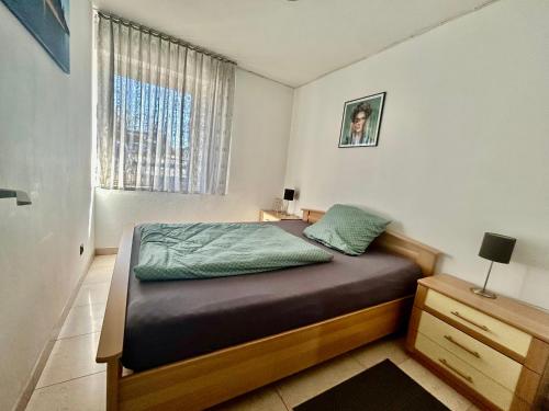 a small bedroom with a bed and a window at Fewo Körbecke am Möhnesee in Möhnesee