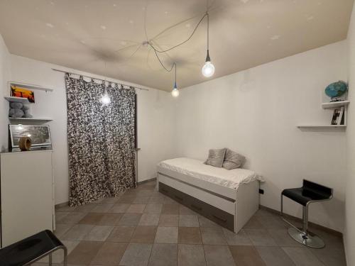 a small bedroom with a bed and a window at Ca Rene in Savigliano