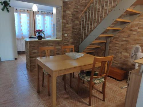 a dining room with a wooden table and chairs at Casa Arianna in Pellestrina