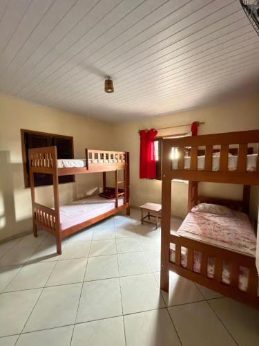 a room with two bunk beds and a ceiling at Lazer Hostel in Barreirinhas