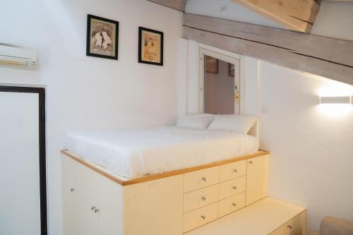 a bedroom with a bed and two pictures on the wall at Urban Studio Apartment in Brescia