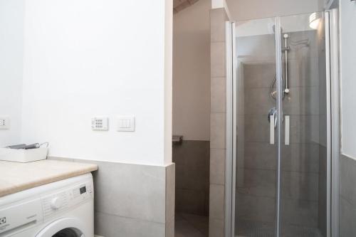 a shower with a glass door in a bathroom at Urban Studio Apartment in Brescia