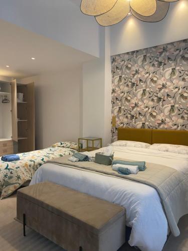 a bedroom with a large bed with a large wall at Castro Romano VUT 7712 AS in Gijón