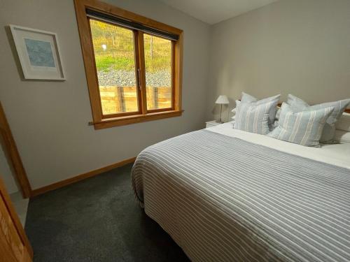 a bedroom with a large bed and a window at 1860 Lawrence Cottage in Lawrence