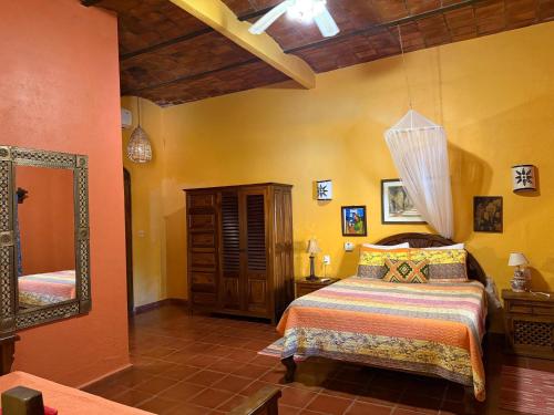 a bedroom with a bed and a mirror at Casa Sorpresa in Sayulita