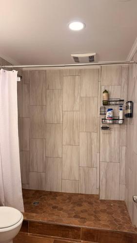 a bathroom with a toilet and a shower stall at Private Two Queen Beds Room Near UPEI & Downtown Cozy Retreat Near Everything in Charlottetown