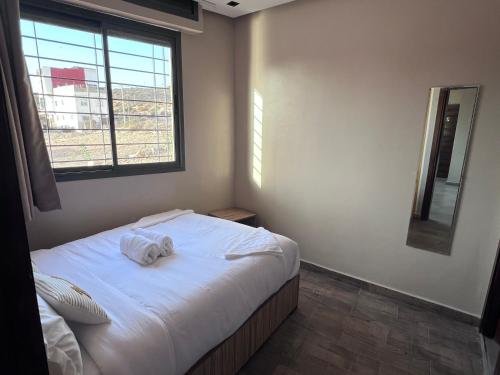 a bedroom with a bed with two towels on it at Appartement No 2 à Tamraght in Tamraght Ouzdar