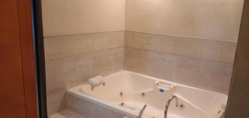 a bath tub in a bathroom with a shower at Posada Alto Verde in Belén