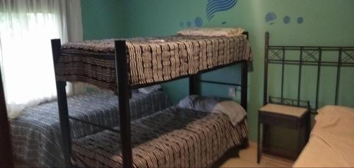 a bedroom with two bunk beds in a room at Posada Alto Verde in Belén