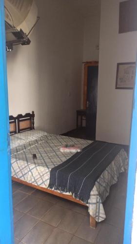a bedroom with a large bed in a room at Pousada Regis Bocaina SJB in São José do Barreiro