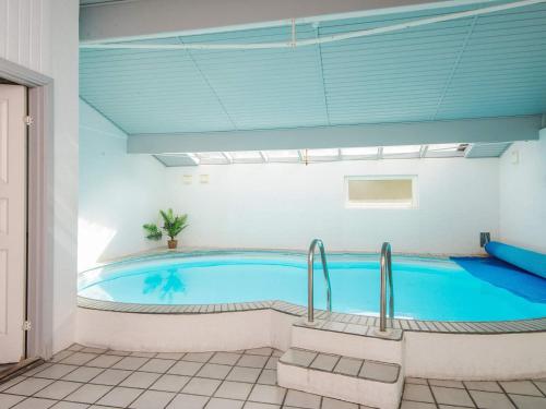 a large swimming pool in a room with at 8 person holiday home in Ørsted in Kare