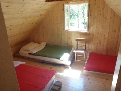 a room with two beds in a log cabin at Holiday Home Rizvan City in Brušane
