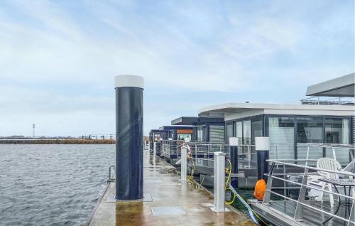 a dock with a building next to the water at 2 Bedroom Nice Ship In Lelystad in Lelystad