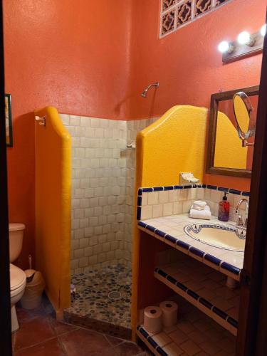 a bathroom with a sink and a mirror at Casa Sorpresa in Sayulita