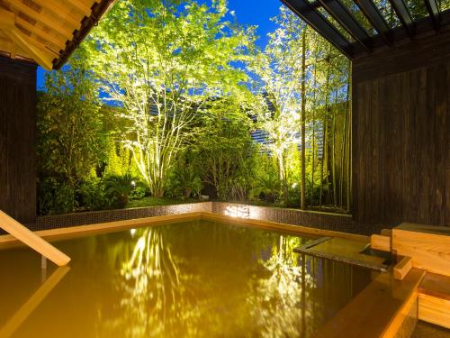a swimming pool in a house with a garden at Kobe Bay Sheraton Hotel & Towers in Kobe