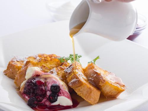 a plate of french toast with a cup of coffee at Kobe Bay Sheraton Hotel & Towers in Kobe