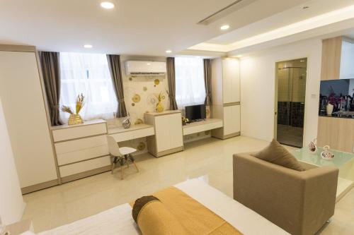 a bedroom with a bed and a desk and a chair at CA&SA Serviced Apartment in Phnom Penh