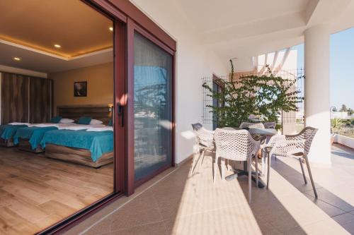 a bedroom with a bed and a table and chairs at Apartments Kan in Ulcinj