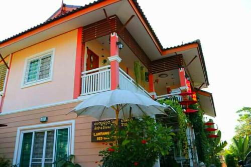 a house with an umbrella in front of it at Lampang Lanna Home in Lampang