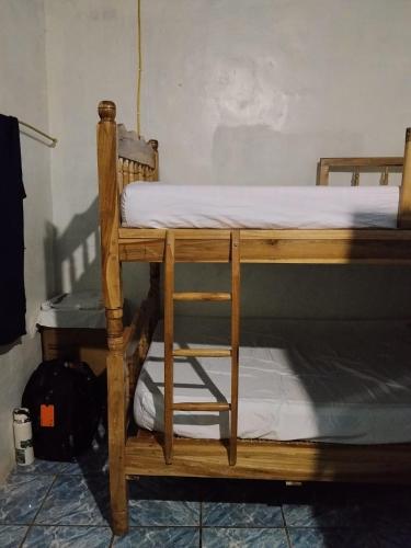 a bunk bed with a ladder on top of it at SWELL house, EL TUNCO in El Sunzal