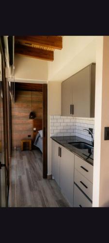 a kitchen with white cabinets and a counter top at Tierra Viva in Purmamarca