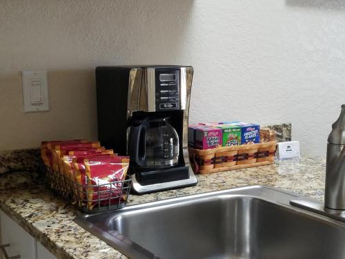 a coffee maker sitting on a counter next to a sink at C & D Restawhile in Oak Harbor