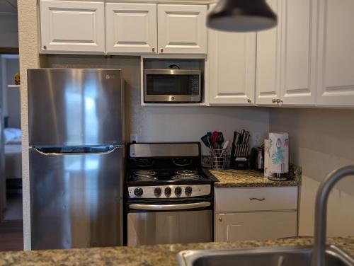 a kitchen with a stainless steel refrigerator and microwave at C & D Restawhile in Oak Harbor