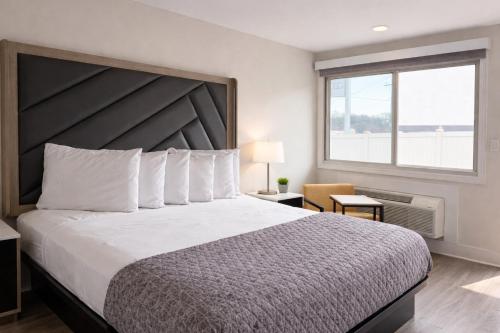 a bedroom with a large bed and a window at Fair Motel in Upper Saddle River
