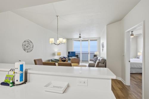a white apartment with a living room and dining room at Summerwind 1202C in Navarre