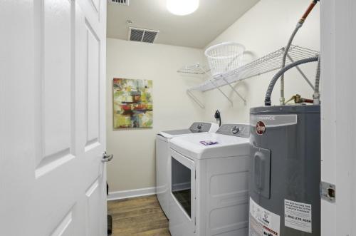 a laundry room with a washer and dryer at Summerwind 1202C in Navarre