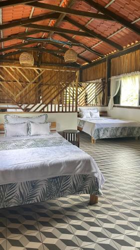 a bedroom with two beds in a building at La Villa de los Alas - Boutique in Juayúa