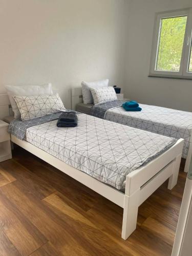 two beds sitting next to each other in a room at Villa Una-Adi-Ela in Bihać